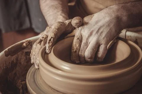 Elderly man making pot using pottery wheel in studio Stock Photos