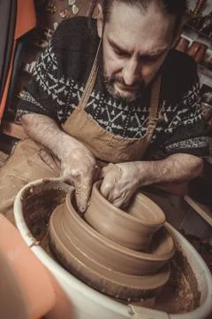 Elderly man making pot using pottery wheel in studio Stock Photos
