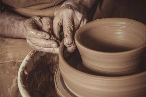 Elderly man making pot using pottery wheel in studio Stock Photos