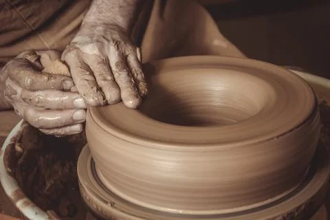 Elderly man making pot using pottery wheel in studio Stock Photos