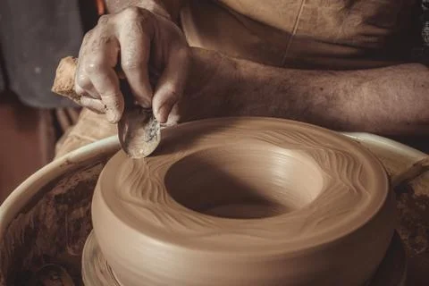Elderly man making pot using pottery wheel in studio Stock Photos