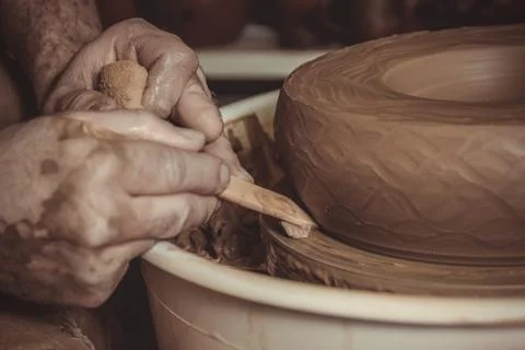 Elderly man making pot using pottery wheel in studio Stock Photos