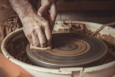 Elderly man making pot using pottery wheel in studio Stock Photos