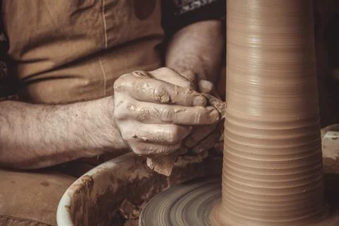 Elderly man making pot using pottery wheel in studio Stock Photos