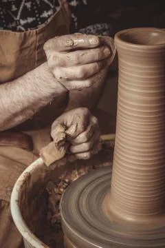 Elderly man making pot using pottery wheel in studio Stock Photos