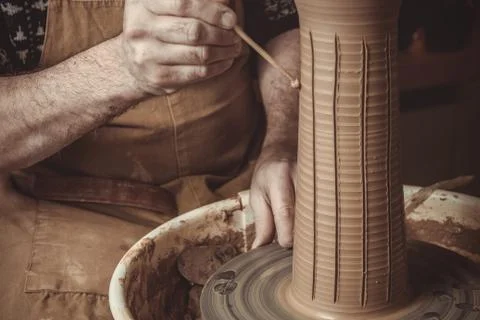 Elderly man making pot using pottery wheel in studio Stock Photos