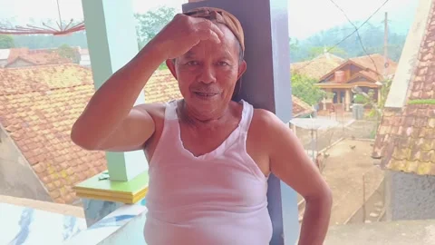 Elderly man massaging head with headache at village home Stock Footage 316448677