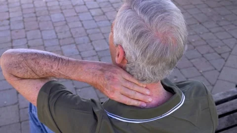 Elderly man massaging neck due to strong pain discomfort Stock-Footage 333194836