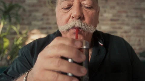 Elderly man with a moustache drinking Stock Footage 275498563