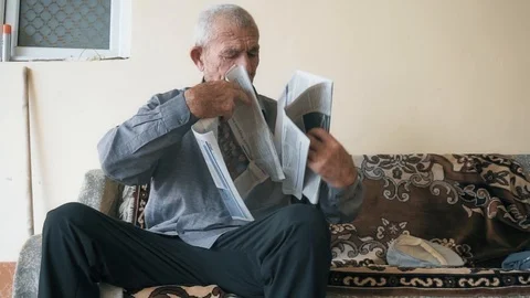 Elderly man with newspaper Stock Footage 95679604