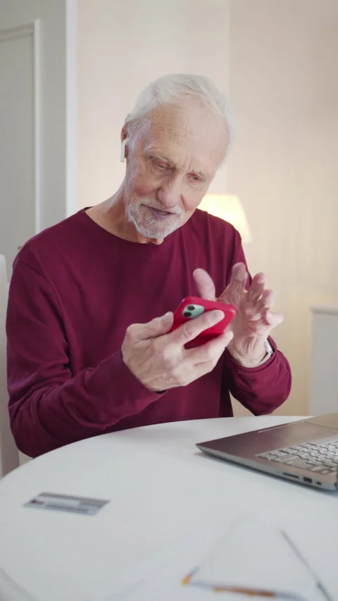 An elderly man is not good at managing a smartphone. He presses the screen but Stock Footage 173573003