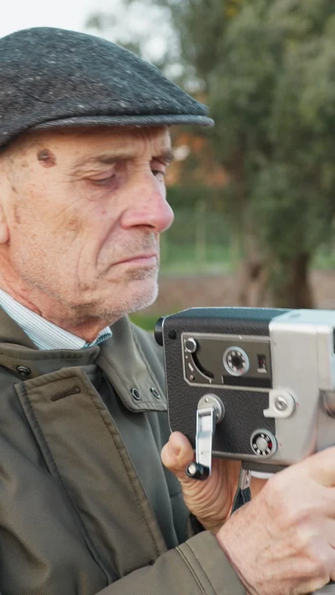 Elderly Man Notices Something Wrong While Filming with His Old Camera Stock Footage 315945549