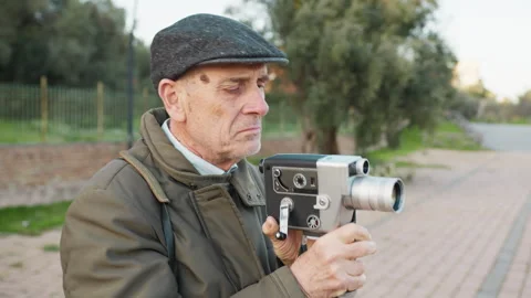 Elderly Man Notices Something Wrong While Filming with His Old Camera Stock Footage 315962132