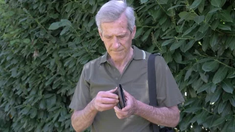 Elderly man opening empty wallet feeling despair and stress Stock Footage 333194695