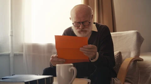 Elderly man opening envelope, shocked to read eviction notice, financial debts Video stock 310008922