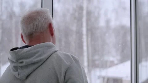 An elderly man opens the window and looks out Stock Footage 167105654