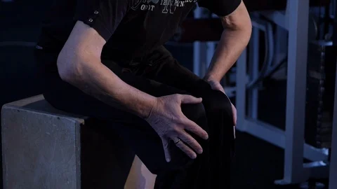 Elderly man performs isometric exercise, kneeling to the sides and back.close-up Stock Footage 115848580