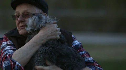 Elderly Man picks up Dog Stock Footage 37345407