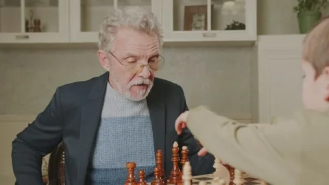 An elderly man is playing chess alone at home. Stock Footage 235015745