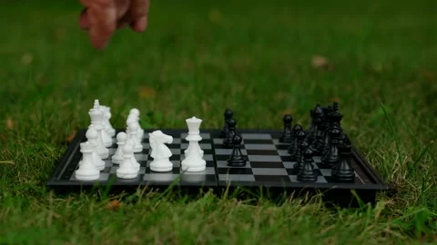 Elderly man playing chess on the lawn. Two old men to play board game. Stock Footage 210554227