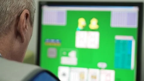 An elderly man playing on the computer. Stock Footage 99969024