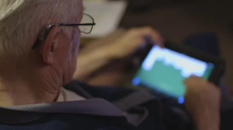 Elderly man playing solitaire on iPad Stock Footage 37345179