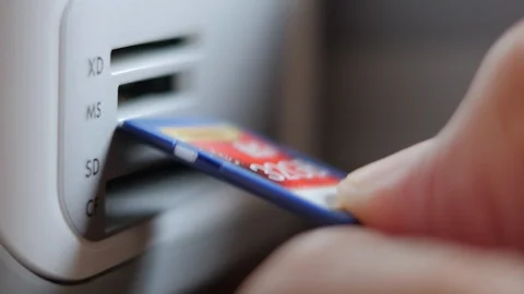 An Elderly Man Plugging SD Memory Flash Card Into A Slot Of Printer Stock Footage 92703557
