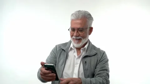 Elderly man pose with smartphone, read received sms with great commercial offer Stock Footage 223181408