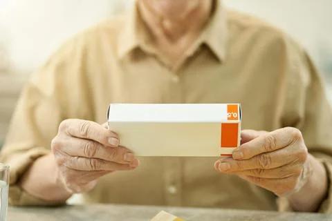 Elderly man posing with a packaged medication Stock Photos