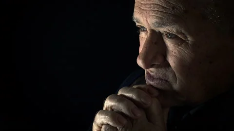 Elderly man praying in the darkness: old sad man searching for God Stock Footage 56152231