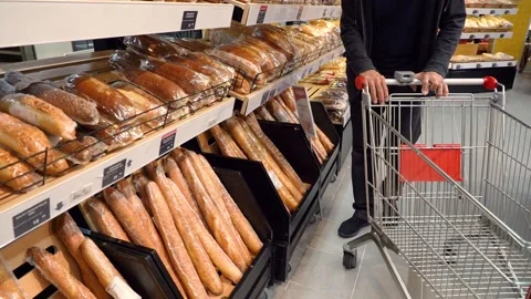 Elderly man puts bread in a cart Stock Footage 133781278