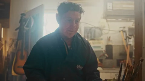 An Elderly man reaching for the brushes Stock Footage 275299824