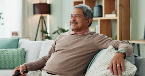 Elderly man, remote control and watching television on sofa on retirement, rest Stock Footage 270694429