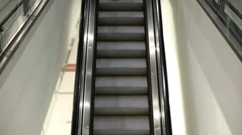 Elderly man riding down escalator Stock Footage 1138854
