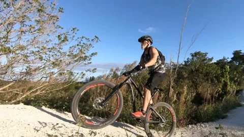 Elderly Man Riding Over Two Hills Stock Footage 200895896