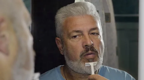 Elderly man shaving and performing various grooming activities to the face Video stock 46166576