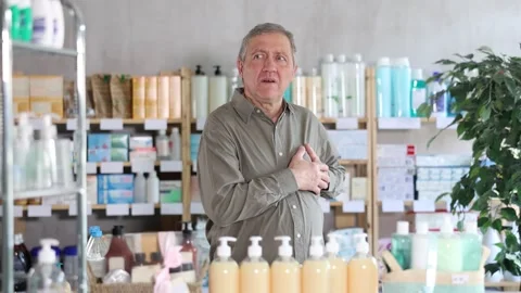 Elderly man in sixties suddenly feeling heart pain and grabbing chest while Stock Footage 329393005