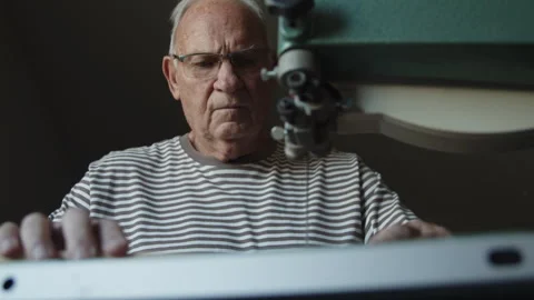 Elderly man skillfully working with table saw in woodworking project Stock-Footage 312712843