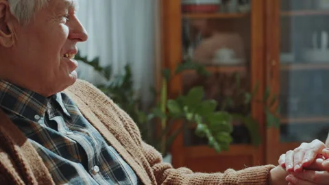 Elderly Man Smiling and Talking with Granddaughter Holding His Hands Stock Footage 265370398