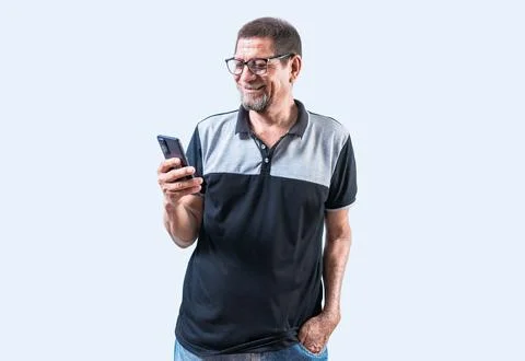 Elderly man smiling using cell phone isolated. Cheerful old man using phone.. Stock Photos