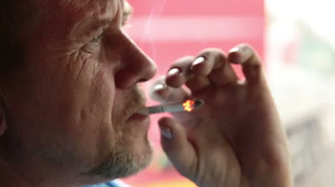 An elderly man smokes a cigarette Stock Footage 32862915