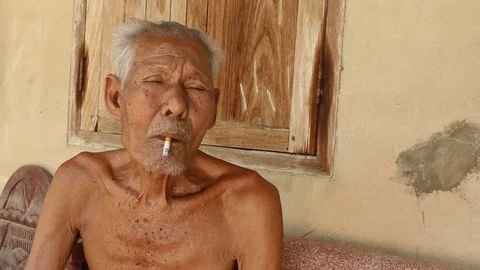 Elderly man smoking Stock Footage 73706758