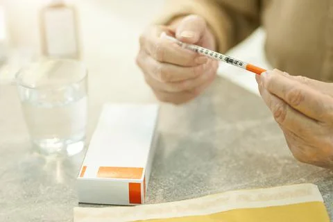 Elderly man sorting out his medical supplies Stock Photos