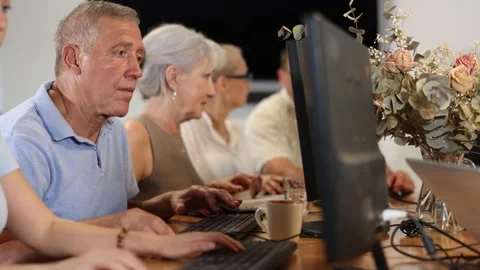 Elderly man studying at computer course in group Stock Footage 312632591