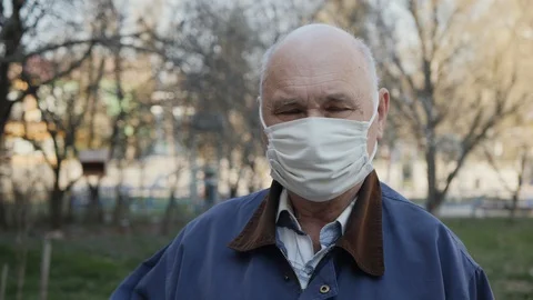 Elderly man taking off his face mask Stock-Footage 128843031