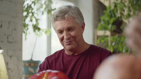Elderly man talking to family while preparing for halloween Stock Footage 163254866
