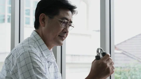 Elderly man think and using hand gripper for exercise, sitting on chair, feel Video stock 138306280