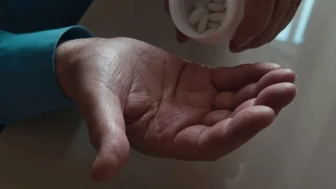 Elderly Man Throws Pills Into His Hand From A Plastic Container Stock Footage 75333196