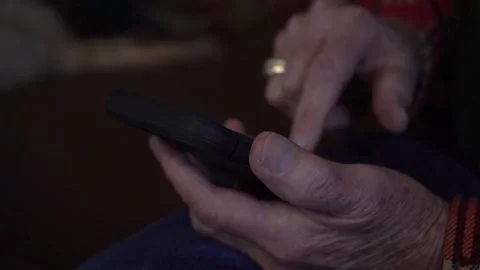An elderly man typing a text message on a smart phone Stock Footage 237013823