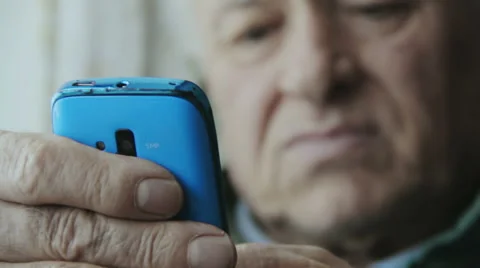 Elderly man typing on the touchscreen of a smartphone: mobile phone, cellular  Video stock 48058654